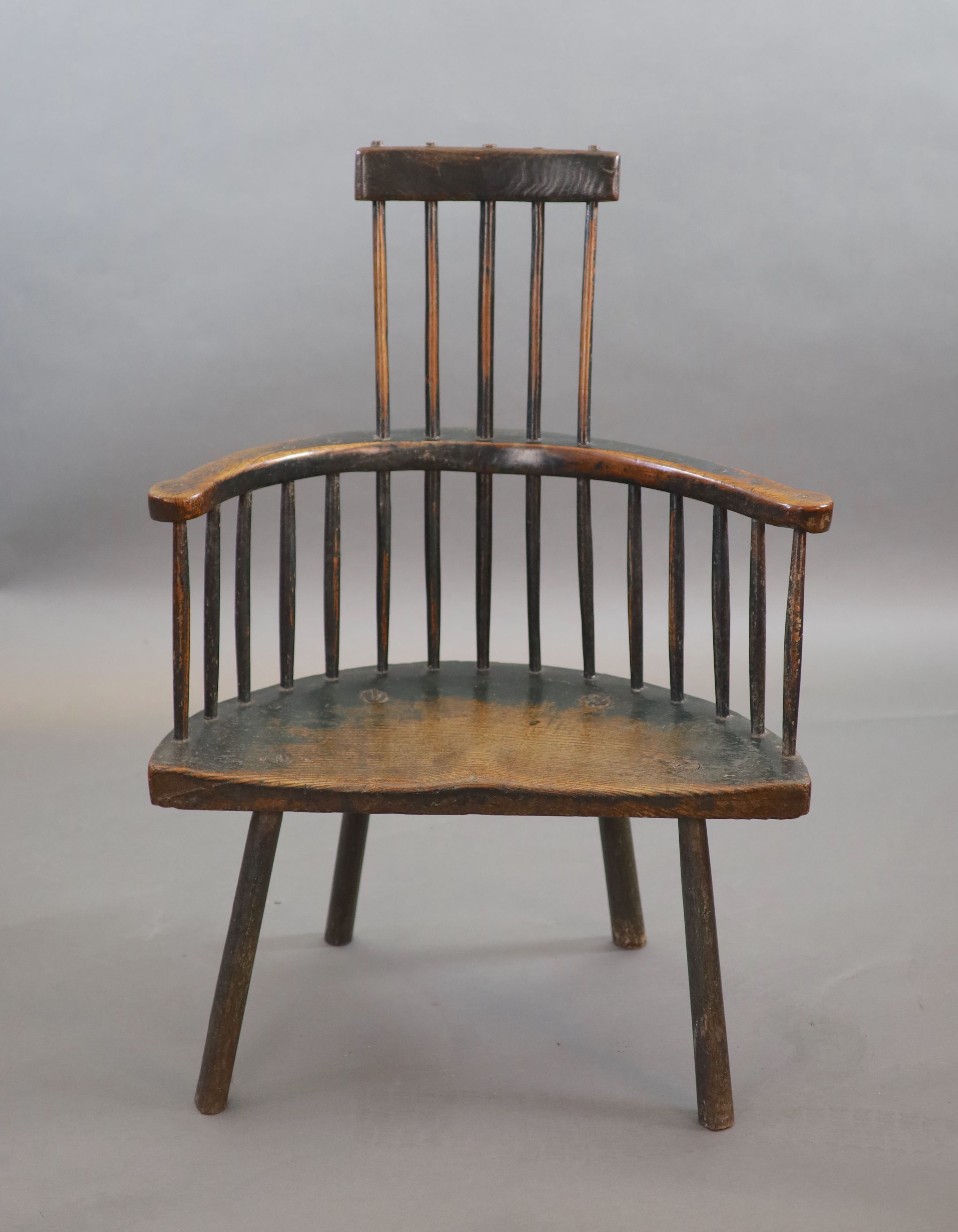 An 18th century primitive vernacular comb-back elbow chair, possibly Welsh, 70cm wide, 34cm deep, 99cm high.